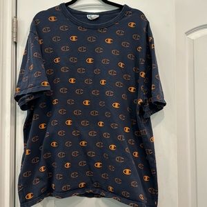 Champion t-shirt. Navy covered in orange “C” Champion logos. XXL